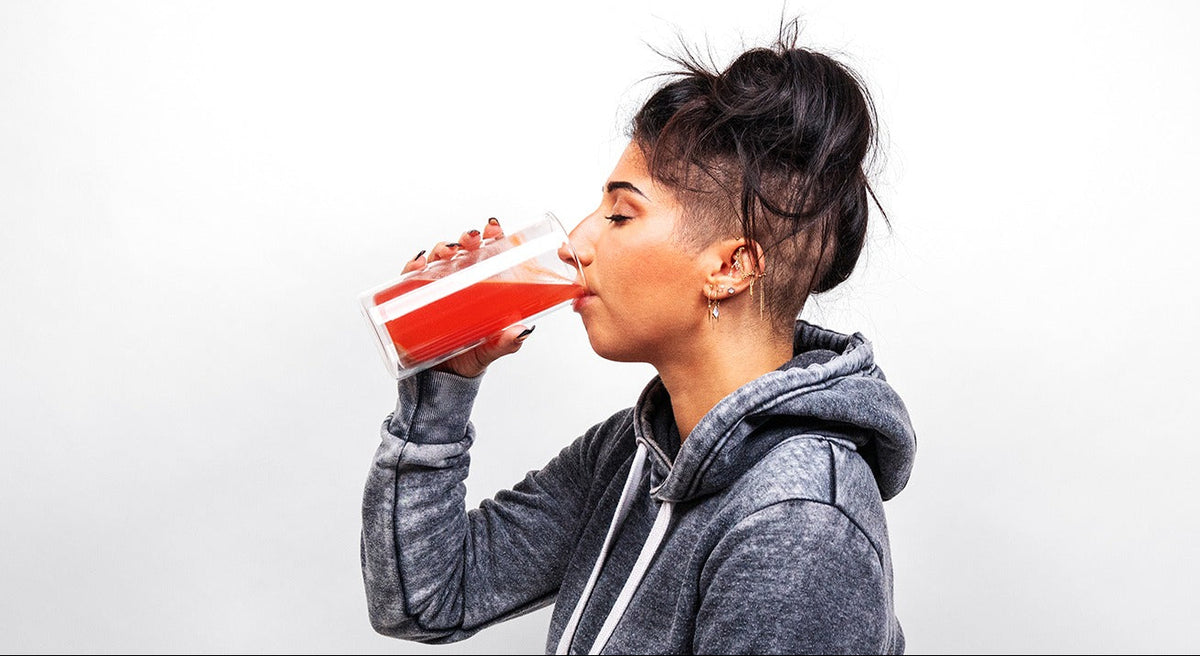 Drinking a glass of NEWBRAIN Strawberry Lemonade