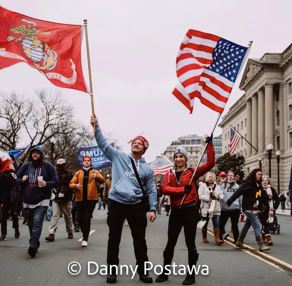 Crowds marching in Washington DC with American and Marine Corps flags